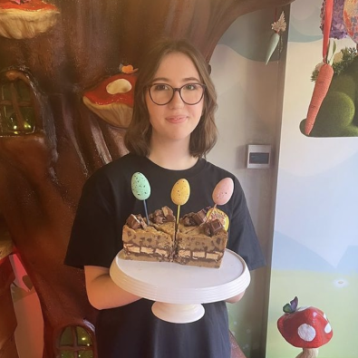 Heidi in the store holding cookie pies